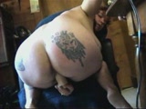 Tatted amateur ass rides a dildo